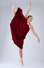 Image showing Ballet, talent and woman in studio for training, creative routine and ready for performance, show or artist with movement on grey studio background. Dancer, ballerina or female performer with balance