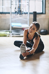 Image showing Portrait, smile and woman stretching, fitness and workout goal with balance, stress relief and happiness. Face, female person or athlete on the floor, stretch legs and training for wellness or health