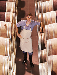 Image showing Man, wine and cellar portrait smile at work in alcohol industry as an employee at warehouse. Winery, expert and storage plant as a worker for job as profession in catering drink for happiness.