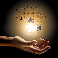 Image showing Closeup, Africa and hand with a puzzle, development and problem solving for growth, future and planning. Zoom, fingers or person with symbol, solidarity and support for global innovation and solution