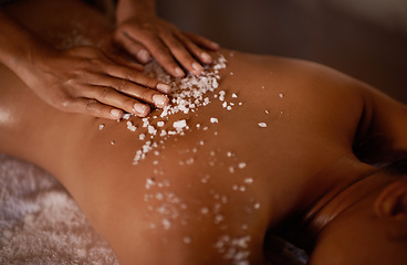 Image showing Salt, spa scrub and beauty therapist hands with woman customer at a hotel with massage. Exfoliate therapy, luxury and relax treatment of a female person back for skincare and wellness exfoliation