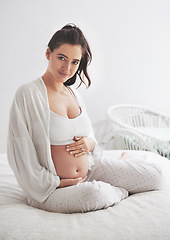 Image showing Portrait, pregnant and woman on a bed, maternity leave and happiness with rest, relax and healthy. Face, female person and mother touching stomach, pregnancy and lady in a bedroom and break at home