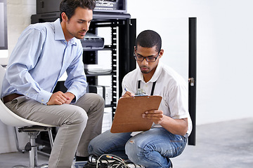 Image showing Server, men and staff with a clipboard, talking and planning with cyber security, tech support and teamwork. Male employees, coworkers and programmers with IT, consultation and software update