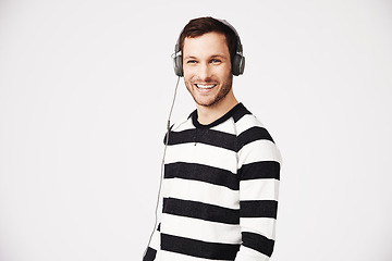 Image showing Man, portrait and headphones with music and podcast with happiness and listening. Isolated, white background and male person hearing web audio and song streaming with a happy smile in studio