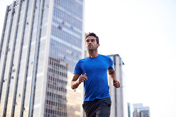 Image showing Fitness, workout and man running in the city for health, wellness or training for a marathon. Sports, runner and male athlete doing an outdoor cardio exercise for endurance or speed in an urban town.