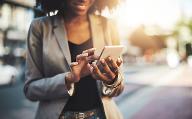 Image showing Business woman, hands and phone in city for social media, communication or texting outdoors. Hand of female employee chatting online, email or mobile smartphone app or networking in urban town street