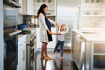 Image showing Happy family, pregnant woman with boy child and in kitchen at their home with lens flare. Mother with love or care, mother and cheerful parent with son bonding with dance in their house together