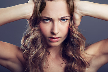 Image showing Face, angry or frustrated young woman and in a studio background. Serious or concerned portrait, health wellness and female model isolated alone with headshot in backdrop for skincare or cosmetic