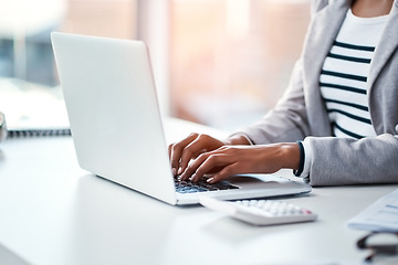 Image showing Hands, businesswoman typing on laptop and in office sitting at her desk at work. Social networking or technology, business and female person type an email or write a financial report at her workplace
