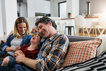 Image showing Mother, father and kid laughing on sofa in living room for love, care and fun bonding together in family home. Happy young boy, cute child and relax with parents in lounge, happiness and smile