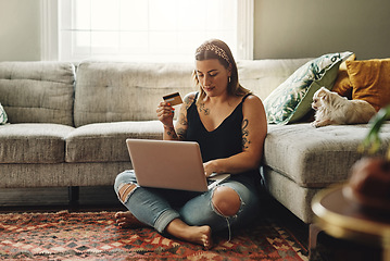 Image showing Laptop, credit card and woman in home online shopping, ecommerce and fintech application, loan or finance on floor. Gen z person typing, banking or website on computer, digital payment or transaction