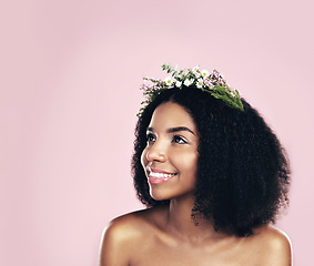 Image showing Flowers, crown and woman thinking of beauty in studio, pink background and mockup of natural afro hair care. Face, happy african model and daydream with floral wreath, spring aesthetic and eco ideas