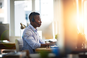 Image showing Virtual assistant, consultant or black man typing in call center consulting online at customer services help desk. Contact us, email or African agent in telemarketing or telecom company in CRM office