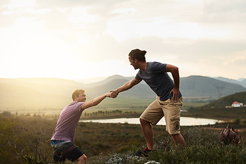 Image showing Hiker helping friend while hiking, fitness and men outdoor trekking in nature or countryside for exercise and travel. Young people hike together, support and adventure with friends, bond and workout