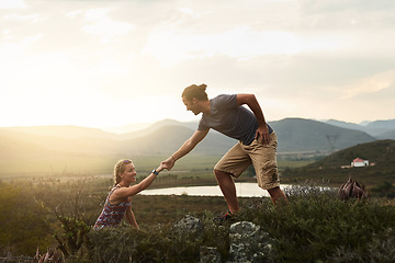 Image showing Man helping woman while hiking, fitness and couple outdoor trekking in nature or countryside for exercise and travel. Young people hike together, support and adventure with date, bonding and workout