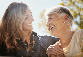 Image showing Family, love or happy with a senior mother and daughter bonding outdoor together during a summer day. Smile, flare and retirement with a young man hugging her elderly parent outside in the park