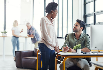 Image showing Modern office, man and black woman coworking with discussion, smile and advice at start up design agency. Computer, desk and happy team leader with designer for help and creative opinion in workplace