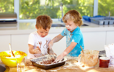 Image showing Baking, children and messy friends in the kitchen together, having fun with ingredients while cooking. Kids, food and bake with naughty young brother siblings making a mess on a counter in their home