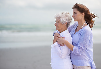 Image showing Beach, young woman and her senior mother embrace or look at horizon outdoors. Mock up, free and hugging elderly woman with adult daughter or at sea or ocean thinking for affection and leisure