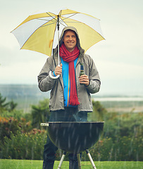 Image showing Happy man, umbrella and barbecue in rain with beer for meal, supper or dinner on the fire grill. Male person smiling for insurance, cover or protection while cooking under raining or stormy weather