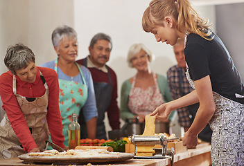 Image showing Food, senior cooking class and a woman teaching people in the kitchen of a home for meal preparation. Pasta maker, equipment and learning with mature friends watching a female chef follow a recipe