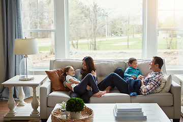 Image showing Love, smile and family on a couch, playing and bonding to relax , home and cheerful on a weekend break. Parents, mother and father with children, kids and happiness with joy, loving and chilling