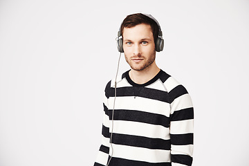 Image showing Man, music portrait and headphones with podcast with relax listening and mockup. Isolated, white background and male person hearing audio and online song streaming with internet radio track in studio