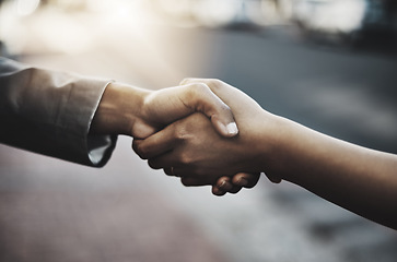 Image showing Business people, handshake and meeting in city for b2b, partnership or introduction and greeting outdoors. Hand of employees shaking hands for team collaboration, agreement or deal for hiring in town