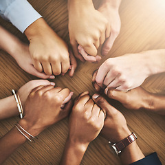 Image showing Community, trust and friends holding hands by table at group counseling or therapy session. Gratitude, love and top view of people in circle for praying together for religion, community and connect.