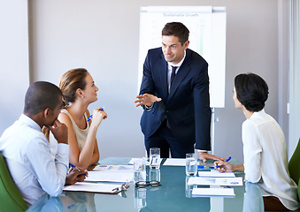 Image showing Business man, speaker and meeting of a corporate management team with sales talk. Speaking, businessman and agency collaboration of company staff working in a conference room with vision strategy