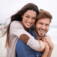 Image showing Piggyback, love and portrait of couple at a beach, hug and laughing while bonding outdoors. Face, embrace and happy man with woman at the ocean for travel, freedom or vacation, holiday or Mexico trip