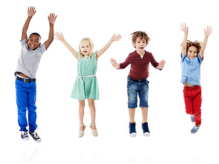 Image showing Happy, jumping and portrait of children in studio for diversity, friends and playing. Happiness, youth and smile with group of kids isolated on white background for celebration, playful and energy