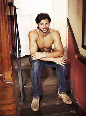 Image showing Happy portrait, shirtless and a sexy man on stairs with a smile, confidence and positive mindset. A happy male model person sitting on steps for art deco, fitness and fashion in apartment or house