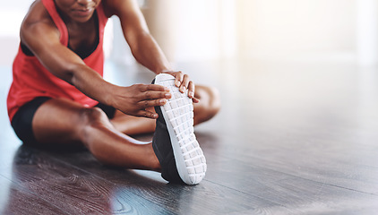 Image showing Fitness, African woman stretching for healthy exercise and in studio or gym. Athlete hands training or workout on mockup space, shoe closeup and female person stretch legs for body goals or wellness