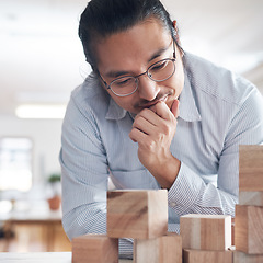 Image showing Thinking, ideas and Asian man in office with building blocks, strategy game and design balance with innovation. Engineering, architecture and designer with idea, wood block game and problem solving.