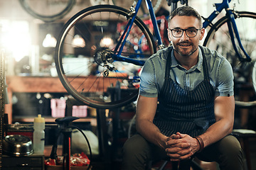 Image showing Portrait, smile and technician man in bicycle shop, store or cycling repair workshop. Face, bike mechanic and male person, confident business owner or mature professional from Canada with glasses.