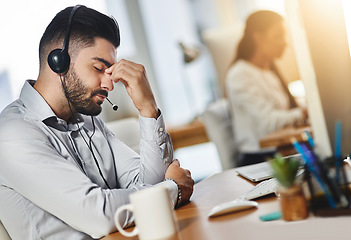 Image showing Headache, tired or man in call center with burnout, head pain or overworked in crm communication. Migraine, office or stressed telemarketing sales agent frustrated with anxiety, fatigue or problem