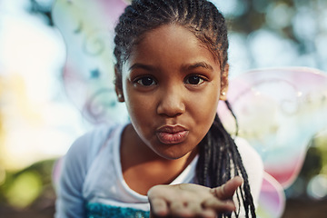 Image showing Kiss, princess costume and portrait of girl in forest for playing fantasy, childhood game and happiness. Nature, fairy tale and face of happy child in woods blowing kisses for love, magic and cute