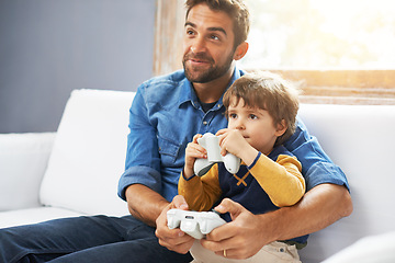 Image showing Video games, father and son on a couch, playing and bonding for quality time, home and relax. Family, happy dad and boy with parent, male child and kid with controller, happiness and entertainment