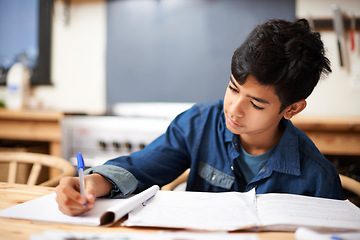 Image showing Education, writing and boy child in a classroom for studying, exam or assignment, focused and serious. Learning, book and male student with notes in an educational lesson, creative and thinking