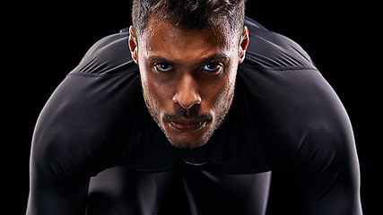 Image showing Portrait, isolated runner and man ready to run, start race and intense focus in dark studio background. Serious, man and running or athlete, cardio or training motivation to win, workout or exercise