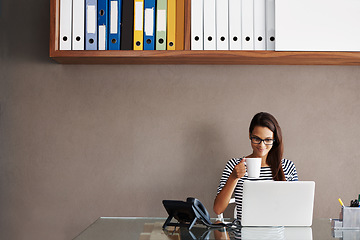 Image showing Laptop, coffee and business woman in office for planning, management and checking email against wall background. Tea, relax and female manager online for project, proposal or creative idea research