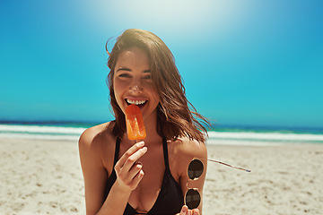 Image showing Ice cream, beach and woman portrait on holiday by the sea and blue sky with happiness. Sun, sand and young female person face with a happy smile and lens flare by the ocean in summer on vacation