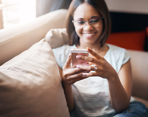 Image showing Relax, smile or happy woman typing on a phone for social media content internet or notification at home. Search, scroll or girl smiling or posting, chatting or texting on online networking mobile app