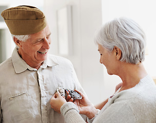 Image showing Military veteran, man and woman with medal, uniform and smile together with memory, pride and success. Elderly couple, army badge or regalia with happiness, check and retirement from service in house