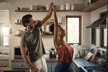 Image showing Interracial couple, happy and dance in kitchen for fun bonding, love or holiday together at home. Man and woman dancing in joyful happiness for relationship, romance or enjoying weekend in the house