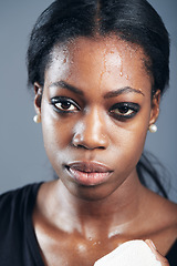 Image showing Portrait, boxing and a woman sweating in studio on a gray background for self defense, fitness or training. Face, exercise and workout with a black female boxer practising for a fighting competition