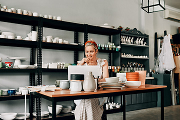 Image showing Creative, pottery and woman sitting with laptop in workshop. Small business or startup, technology or social networking and female person in kitchen with art sculpture on the table or on desk