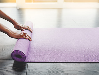 Image showing Hands, closeup and yoga mat roll on floor for exercise, meditation or spiritual training in home, gym or room. Black woman, workout mockup or prepare for pilates and balance, fitness and wellness