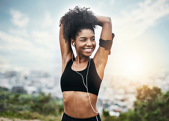 Image showing Happy, woman and stretching arms for running outdoors with music for fitness, workout or cardio routine. Stretch, exercise and smiling African female runner in nature with podcast for training run